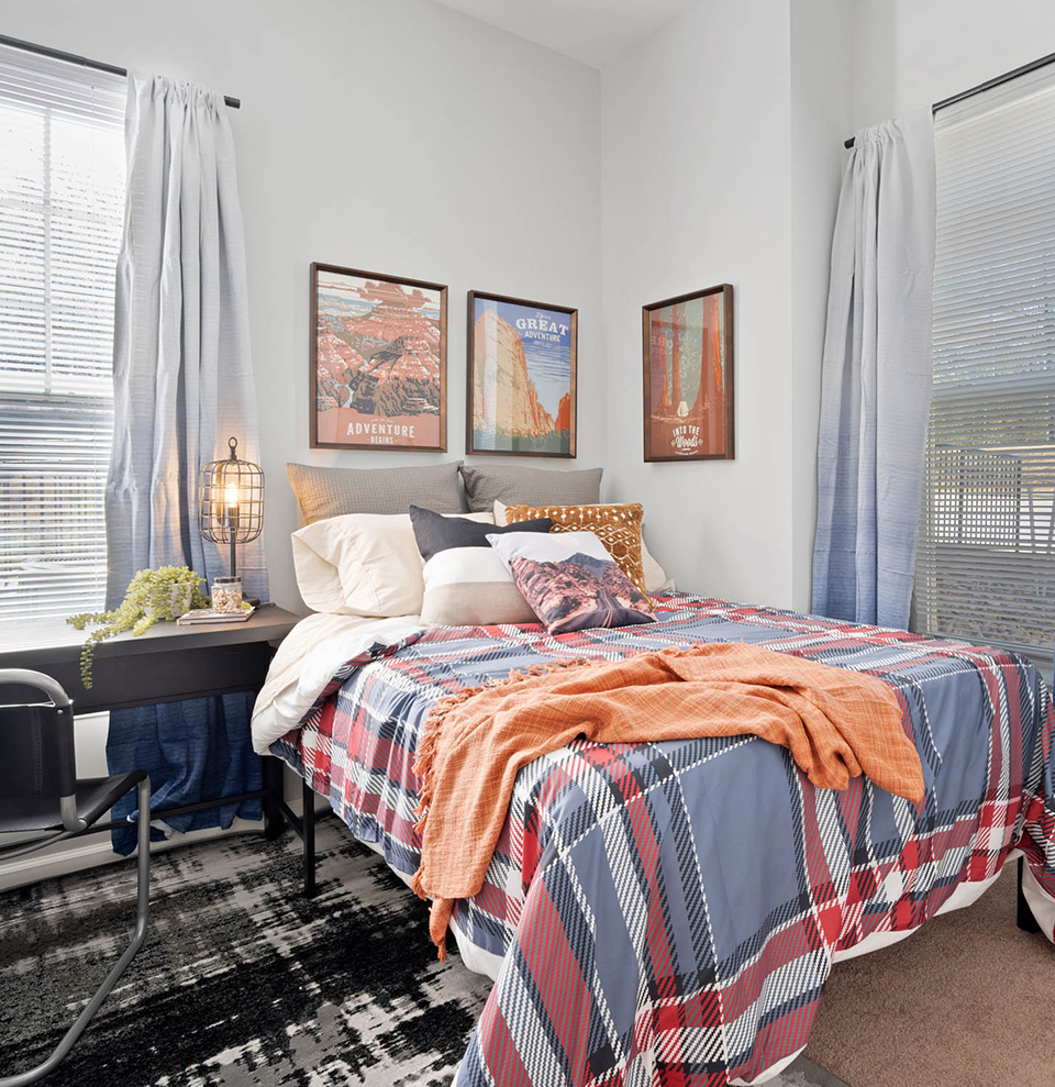 A bedroom with a study desk