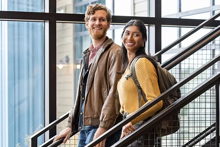 two happy people going down some stairs